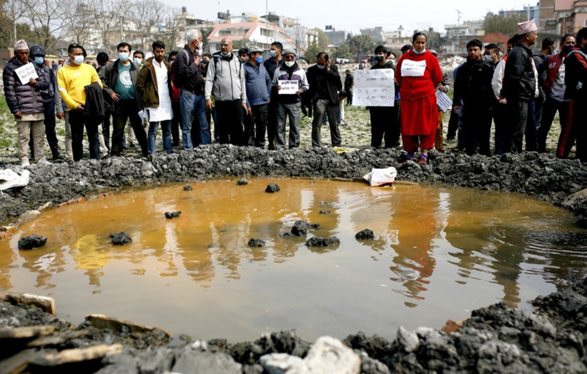 Civil Society campaigners dismantle concrete structure at Kamalpokhari